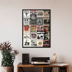 a wooden table topped with a record player next to a plant