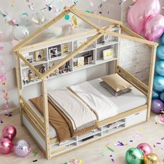 a dollhouse bed with balloons and confetti around it