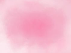 a blurry pink background with white clouds