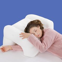 a woman is laying down with her head on the pillow