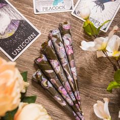 flowers and cards on a table next to each other