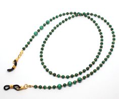 Malachite gemstone glasses chain. The chain is made using 4mm and 6mm malachite gemstone beads and tiny spacer beads in gold (pictured), silver or rose gold. The chain can also be made without spacer beads, simply gemstones alone. The chain can be made in a variety of lengths. Please choose desired finish and length from drop-down menu. Perfect for keeping your glasses at hand and secure. Wrapped in tissue paper and presented in an organza pouch ready to gift. Handmade Green Glasses Chains With Round Beads, Green Beaded Glasses Chain Gift, Green Beaded Glasses Chain As Gift, Green Beaded Chain Glasses For Gift, Green Round Beaded Glasses Chains For Gifts, Green Glasses Chains With Round Beads For Gift, Green Adjustable Chain Glasses Chains As Gift, Green Adjustable Glasses Chain As A Gift, Elegant Green Glasses Chains For Gift