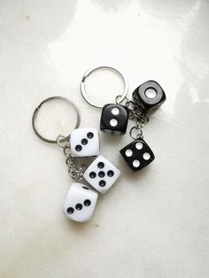 three dice shaped key chains sitting on top of a table