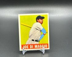 a baseball card with a man holding a bat on it's back and the name joe di maggio