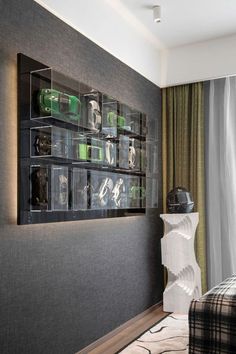 a room with a bed and a wall mounted shelf filled with glass containers on it