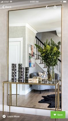 a living room with a large mirror on the wall