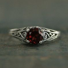 Garnet Engagement Cinderella Ring with Garnet Vintage Style Ring Red Stone Ring Garnet Ring Genuine Mozambique Garnet Antique Style Ring"If you keep on believing, the dream that you wish will come true"Cinderella sparks memories of glass slippers, fairy god mothers, and dancing until midnight. This is her ring...dainty, intricate and as stunning as can be! A detailed filigree setting securely holds a 5mm Genuine Mozambique Garnet. It is surrounded by intricate vining filigree. The top of the ste Classic Red Promise Ring, Red Promise Ring With Round Band, Red Round Band Promise Ring, Red Solitaire Promise Ring, Red Solitaire Ring For Promise, Red Solitaire Ring With Round Band, Classic Red Round Band Rings, Red Garnet Round Band Jewelry, Red Garnet Solitaire Ring