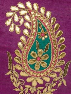 an embroidered purple cloth with gold and green designs on the front, along with leaves and flowers