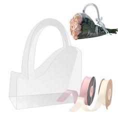 two rolls of tape and a flower in a white bag with pink flowers on it