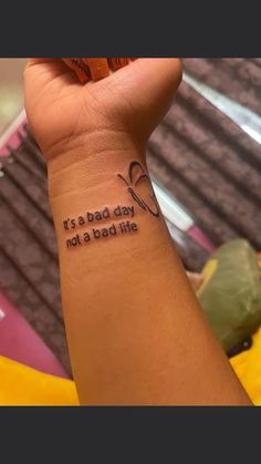 a woman's arm with a tattoo saying it's a bad day not a bad life