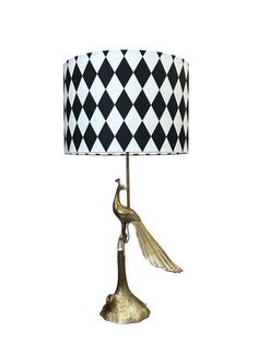 a black and white table lamp with a bird on it's arm, against a white background