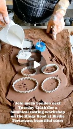 a person is decorating a cake with chocolate icing and other things to make it