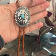 This awesome bolo tie has a southwestern design and agate centerpiece. Handmade in our shop. The cord is available in genuine brown or black leather. Our bolos pair nicely with many of our belt buckles! They make wonderful gifts. The western bolo tie rope length is 40'' ; charm agate stone pendant size is 2'' x 1 1 /2'' Turquoise Bolo Tie, Western Bolo Tie, Turquoise Cross, Southwestern Design, Bolo Tie, Cross Designs, Stone Pendant, Agate Stone, Stone Pendants