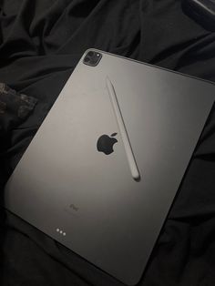 an apple ipad pro is sitting on a bed