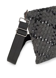 The Haute Shore Shay Edge Woven Phone Bag is a cell phone bag featuring a lined interior, slip pocket, and magnetic closure. Black woven textile body with black metallic accents. Magnetic top closure. Adjustable crossbody 1.5 inch wide strap. Dimensions 8.4 in tall x 5.9 in wide x 2 inches deep. Washable with mild soap. Hang dry. Trendy Phone Bag With Hidden Sleeve For On-the-go, Modern Black Bag With Snap Closure, On-the-go Satchel With Snap Closure, Black Bags With Snap Closure For On-the-go, On-the-go Crossbody Shoulder Bag With Snap Closure, Cell Phone Bag, Hanging Dryer, A Cell, Black Metallic