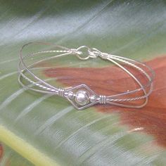 Are you looking for an affordable gift for a special young lady? This is a dainty design of sterling silver wires with a single 6mm center bead. Delicate and fiercely feminine. Perfect for a graduation gift, best friend gift, or holiday stocking stuffer! The built-in hook and eye-type clasp is easy to get on and off. Choose the size from the variations listed for a perfect custom fit! Adjustable Silver Pearl Bracelet For Friendship, Adjustable Silver Pearl Bracelet With Strap, Vintage Sterling Silver Jewelry, Silver Jewelry Diy, Silver Jewellery Indian, Silver Rings With Stones, Silver Jewelry Earrings, Cleaning Silver Jewelry, Bracelet Dainty