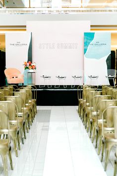 rows of gold chairs in front of a large white board with the words style summit on it