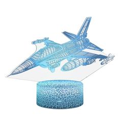 a blue model of a space shuttle on top of a round object next to it