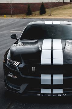 a black and white mustang parked in a parking lot