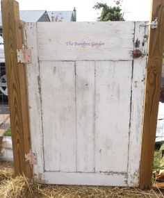 an old white door with purple lettering on it