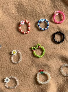 several bracelets are laid out on the sand