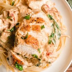 creamy sun dried tomato chicken pasta on a white plate