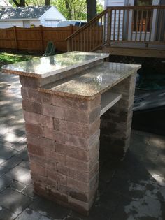 a stone bench sitting in the middle of a yard