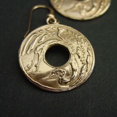 "Hand carved flying Japanese crane earrings. Throughout all of Asia, the crane has been a symbol of happiness and eternal youth. In Japanese, Chinese, and Korean tradition, cranes stand for good fortune and longevity because of its fabled life span of a thousand years. The Japanese refer to the crane as the \"bird of happiness\". The cranes' beauty and spectacular mating dances have made them highly symbolic birds in many cultures with records dating back to ancient times. Crane mythology is wid Elegant Etched Round Earrings, Symbolic Round Earrings For Pierced Ears, Formal Carved Gold Earrings, Gold Etched Earrings As Gift, Formal Gold Carved Earrings, Gold Etched Earrings For Gift, Gift Gold Etched Earrings, Traditional Gold Carved Earrings, Symbolic Engraved Gold Earrings