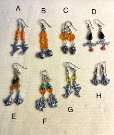 several different types of earrings are displayed on a table with the letters abc, b, c, d, e, f