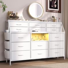 a white dresser sitting in front of a mirror