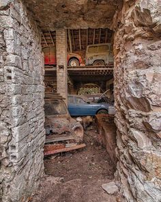 an old car is sitting in the middle of some ruins