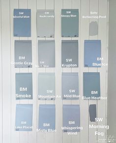 a wall with different shades of blue and white paint on it, all labeled in the same font