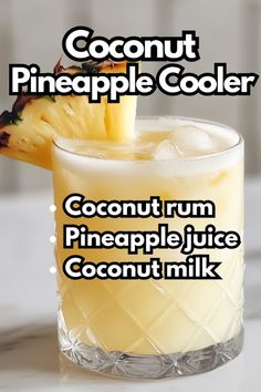 a close up of a drink in a glass with a pineapple on the rim