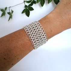 This stunning chainmail bracelet handmade in Mexico. Individually handcrafted with silver plated rings linked together to create this eye-catching piece. The triangular scroll detail at both ends gives it a lovely finish. When it catches the light it shimmers! Elegant and versatile, they are super chic for dressing up and look great for everyday too. If you've got any questions don't hesitate to ask me.    These earrings come gift wrapped in an organza pouch. This is part of a collection of jewe Elegant Chainmail Bracelets As Gift, Elegant Chainmail Bracelet Gift, Elegant Chainmail Bracelet For Gift, Elegant Chainmail Bracelets For Gift, Handmade Adjustable Chain Link Bracelets, Metal Chainmail Bracelets As Gift, Handmade Adjustable Chain Link Bracelet, Silver Chainmail Chain Link Bracelets, Handmade Silver Chain Link Bracelets