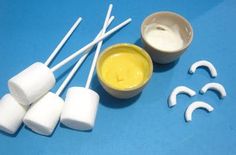 marshmallows, dip and toothpicks on a blue surface