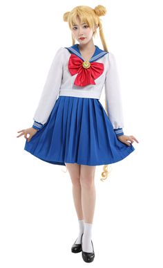 a woman dressed in a sailor costume posing for the camera with her hands on her hips