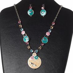 Versatile and artistic necklace and earring set brings eye-catching flair to your wardrobe or fashion displays. Whether you're shopping for yourself or looking to dress up your storefront, it's ready to boost your sales and draw in customers with instant style gratification. Nickel Free Round Pewter Jewelry, Multicolor Hand Painted Metal Jewelry, Hand Painted Multicolor Metal Jewelry, Multicolor Enamel Jewelry With Lobster Clasp, Multicolor Nickel-free Costume Jewelry, Multicolor Nickel-free Round Pendant Jewelry, Nickel-free Multicolor Round Pendant Jewelry, Silver Czech Glass Round Necklace, Round Silver Czech Glass Necklace