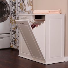 an open laundry cabinet next to a washer and dryer