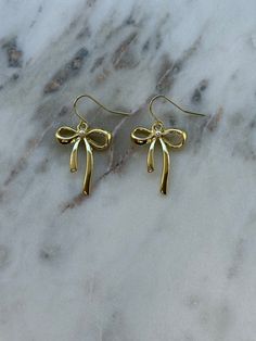 gold bow earrings – ivory moon Gold Jewelry Earings, Gold Earrings With Decorative Bow As Gift, Gold Dainty Bow Jewelry, Dainty Gold Jewelry With Bow Detail, Formal Gold Jewelry With Bow, Dangle Bow Earrings For Gift, Dangle Bow Jewelry As Gift, Dangle Bow Jewelry For Gifts, Gold Dainty Bow Earrings