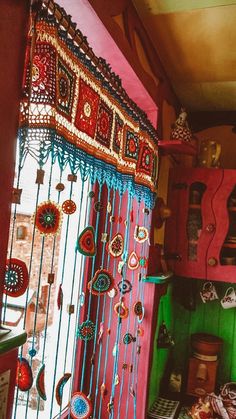 a room filled with lots of colorful items on the floor and walls, all covered in beadwork