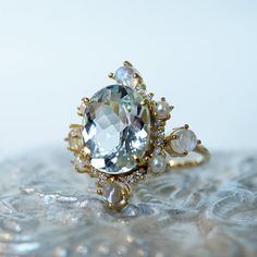 Read about our payment plans before proceeding."Do you want to build a snowman?"- FrozenThe "Aquamarine Elsa Moonstone Pearl Diamond ring" features an approximately 2.54ct oval large natural Aquamarine. Framed with glowy cabochon moonstones, freshwater pearls, and natural white diamonds. Handcrafted in 14k yellow gold, rose gold, and white gold. All orders come in our Tippy Taste ring box. This ring is handmade and designed in NYC. 14K solid gold 10*8mm natural oval Aquamarine. Approx. 2.54ct Fo Unique Wedding Moonstone Ring With Gemstone Accents, Wedding Moonstone Ring With Gemstone Accents In 14k Gold, Aquamarine And Pearl Ring, Celestial Style Moonstone Wedding Ring With Gemstone Accents, Celestial Moonstone Ring With Gemstone Accents For Wedding, Celestial Moonstone Ring For Wedding With Gemstone Accents, Unique Topaz Ring With Gemstone Accents For Wedding, Unique Topaz Wedding Ring With Gemstone Accents, Pearl Diamond Ring