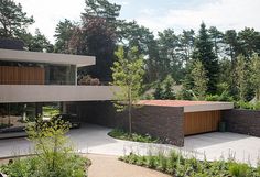 a modern house surrounded by trees and plants