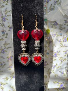 Beautiful double red heart earrings that have a vampire, renaissance/Alice in Wonderland inspired look.  ** While earrings are made to last, they should be treated with care. Not recommended to get wet for long periods of time ** Silver Gothic Earrings For Valentine's Day, Handmade Gothic Jewelry For Valentine's Day, Gothic Heart-shaped Pierced Jewelry, Fantasy Red Jewelry For Party, Gothic Dangle Earrings For Valentine's Day, Gothic Dangle Heart Earrings For Gift, Gothic Handmade Earrings For Party, Handmade Gothic Earrings For Party, Gothic Party Jewelry With Heart Charm