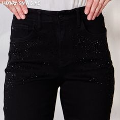 Black Rhinestone Accent Skinny Slim Fit Denim High Rise Waist Jean Pants These special edition rhinestone encrusted Judy Blues will add that touch of glam every outfit is missing.Features bling black stones on the front and back pocket adding a elevated elegance as they slightly blend in.Retro high-waist offers functionality, figure flattering and elongates the silhouette preventing muffin top.Skinny slim fit gives a sleek classy look that can take you from day to night.Equipped with functional Chic Black Bottoms With Rhinestones, Glamorous Jeans For Night Out, Trendy Rhinestone Bottoms For Night Out, Chic High Waist Bottoms With Rhinestones, Party Straight Leg Bottoms With Rhinestones, Chic High Waist Rhinestone Bottoms, Party Bottoms With Rhinestones And Straight Leg, Glamorous Black Bottoms With Rhinestones, Denim Bottoms With Rhinestones For Night Out