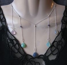 Multi Drop Necklace- Lavender, Aqua, Seafoam & Blue Chalcedony gems hang from twisted rings on 5 chains in this sterling silver bib necklace. Iolite gems & sterling silver beads also accent necklace. Necklace fits 17 inches around the neck with an additional drop of 2 1/2 inches for center stone. Can adjust to 16 inches. Gift box and jewelry polishing cloth included. Visit our shop to see more original designs: http://www.alistdesigns.etsy.com Adjustable Sterling Silver Necklace With Dangling Beads, Silver Drop Necklaces With Faceted Beads, Silver Drop Jewelry With Gemstone Beads, Silver Drop Jewelry With Faceted Beads, Moonstone Drop Earrings, Seafoam Blue, Green Chalcedony, Aqua Chalcedony, Expensive Jewelry