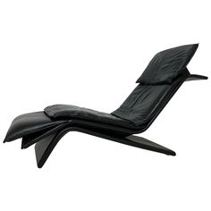 a black leather chaise lounge chair on white background