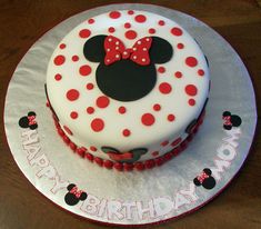 a minnie mouse birthday cake with red and white polka dots