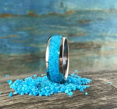 two wedding bands with blue glitter on them