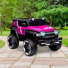 a pink and black jeep with lights on