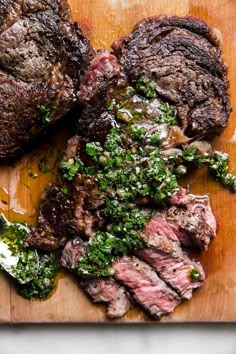 the steaks are prepared and ready to be eaten on the cutting board for consumption